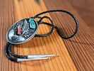 SILVER BOLO TIE WITH TURQUOISE AND CORAL ACCENTS. Silver bolo tie featuring a decorative oval Image - 1