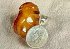 MONUMENTAL STERLING SILVER & AMBER RING. Sterling silver ring featuring a large, polished amber Image - 4