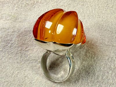 MONUMENTAL STERLING SILVER & AMBER RING. Sterling silver ring featuring a large, polished amber 