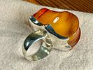 MONUMENTAL STERLING SILVER & AMBER RING. Sterling silver ring featuring a large, polished amber Image - 1