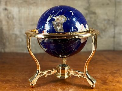 BLUE LAPIS GEMSTONE GLOBE #1. This lot features a vintage blue lapis gemstone globe with a gold 