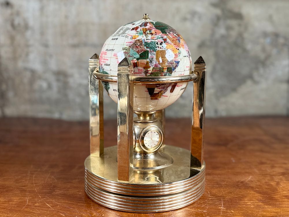 ROTATING GEMSTONE GLOBE. This lot features a vintage rotating gemstone globe set in a brass 