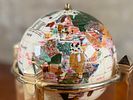 ROTATING GEMSTONE GLOBE. This lot features a vintage rotating gemstone globe set in a brass Image - 2