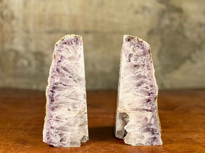 AMETHYST GEODE BOOKENDS. This lot features a pair of large amethyst geode bookends often dating 