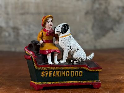 CAST IRON MECHANICAL SPEAKING DOG BANK. This lot features a vintage reproduction cast iron 