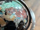 GEMSTONE GLOBE WITH BLACK ONYX OCEAN ON STAND. This lot features a vintage gemstone globe with a Image - 3