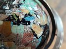 GEMSTONE GLOBE WITH BLACK ONYX OCEAN ON STAND. This lot features a vintage gemstone globe with a Image - 4