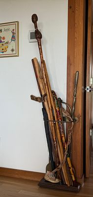 CANE COLLECTION WITH BRASS STAND. This lot features a collection of canes from around the world 