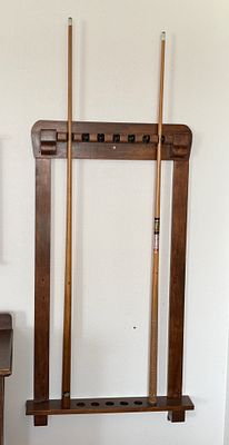 POOL CUE RACK & PAIR OF CUES. This lot features a vintage wooden pool cue rack &amp; a pair of 
