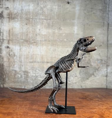 TYRANNOSAURUS REX SKELETON STATUE. This lot features a Tyrannosaurus Rex skeleton statue mounted 