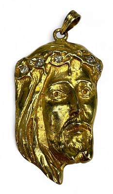 Diamond and 14K Gold Jesus Christ Pendant. Includes approximately four round diamonds measuring 