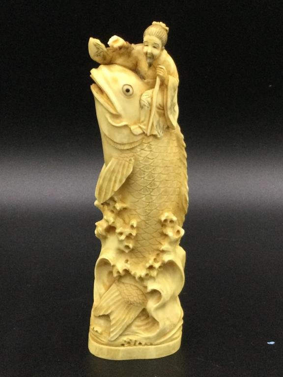 Lot 79: Carved Carp fish with Man
