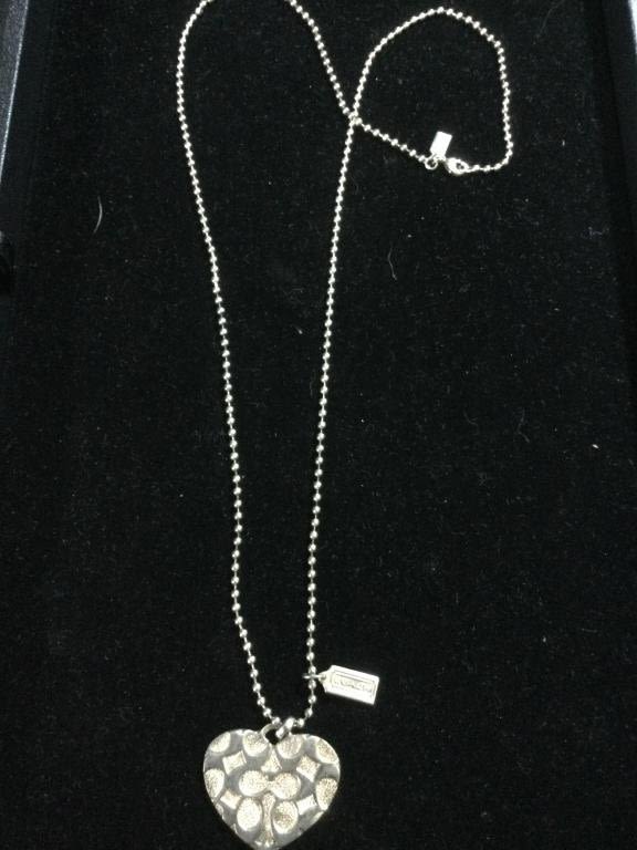 Lot 153: Silver Chain with Coach Pendant