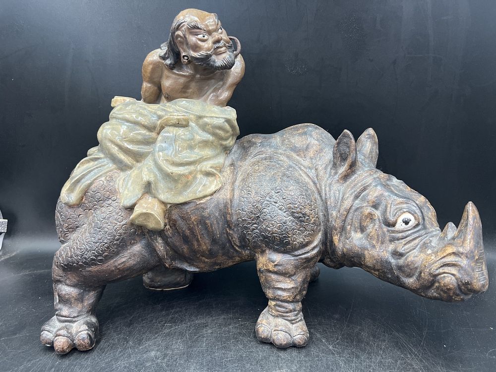Lot 203: Shiwan Ware Figure of Lohan Riding Rhinoceros
