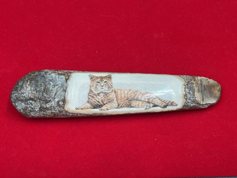 Lot 239: Carved Fossilized Mammoth Cat "Anna Good"