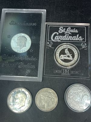 Silver Coins. Total of 5 different coins. There is a Eisenhower (hard case), Morgan, St Louis