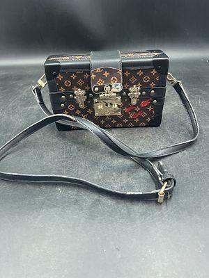 Louis Vuitton Petite Malle Bag. Inspired by LV’s iconic trunks, it features the signature S-lock