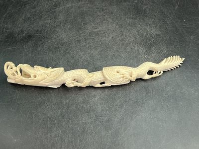 Carved Ivory Dragon Figure. Likely Asian origin where dragons are significant cultural symbols 