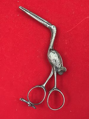 Antique Stork Midwife Clamp. See pictures, hidden swaddled baby inside the body. Measures about 
