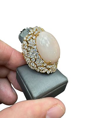An Italian 18K gold ring by the craftsman PELLE D' ANGELO is flexible and inlaid with a natural 