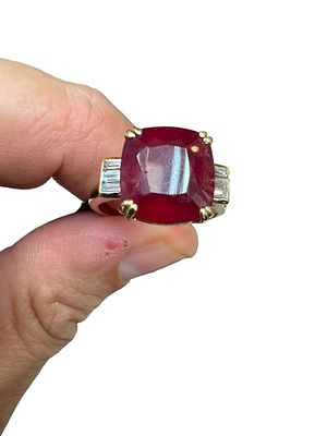 A 14K yellow gold ring weighing 6.1 grams, set with a special natural ruby polished emerald 