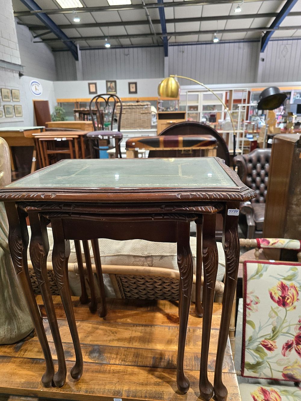 Lot 149: 1 X NEST OF LEATHER TOPPED TABLES