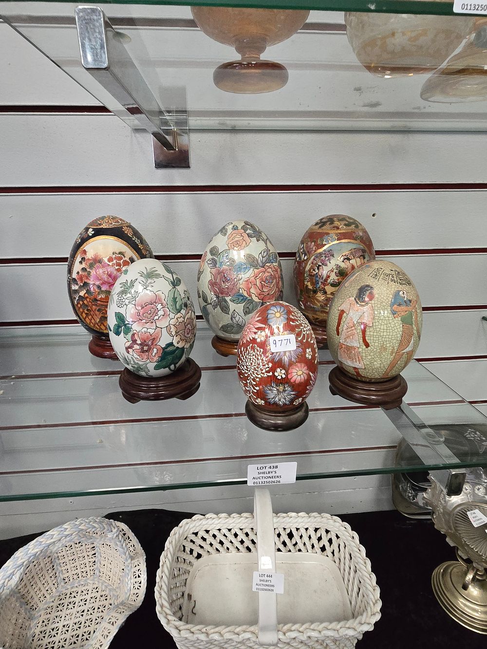 Lot 438: 5 X VARIOUS LARGE PORCELAINE EGGS ON STANDS