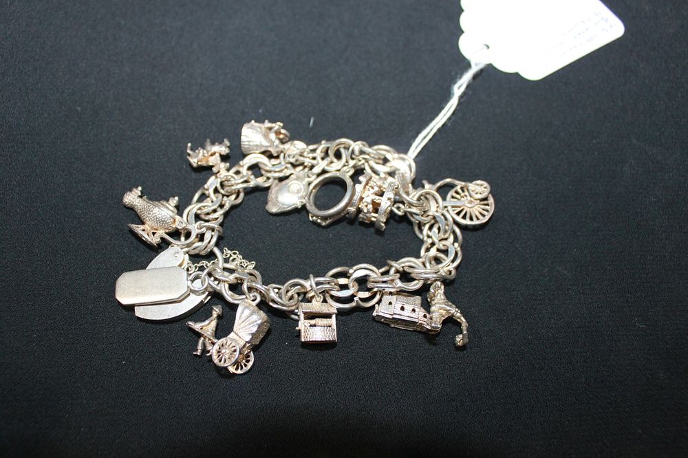 Lot 252: 1 X SILVER CHARM BRACELET WITH 12 SILVER...