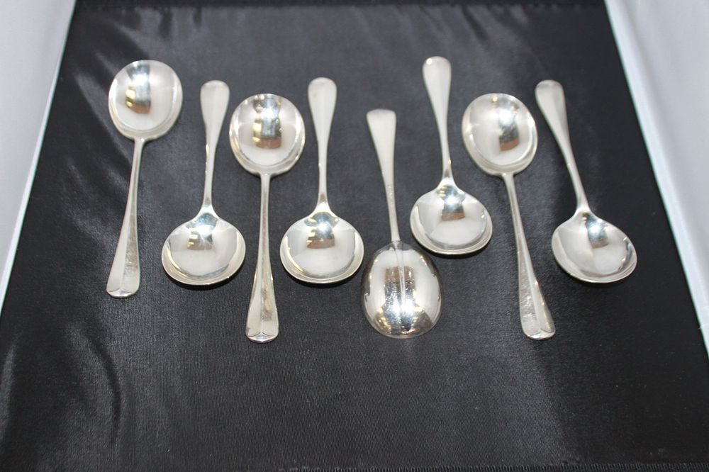 Lot 320: 8 X SILVER SOUP SPOONS WALKER AND HALL...