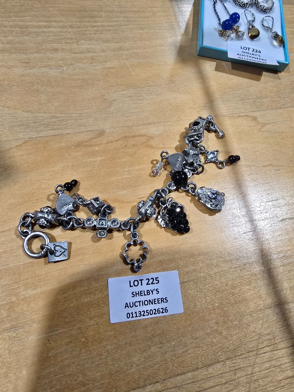 Lot 225: 1 X OTAZU SILVER CHARM BRACELET WITH VARIOUS...