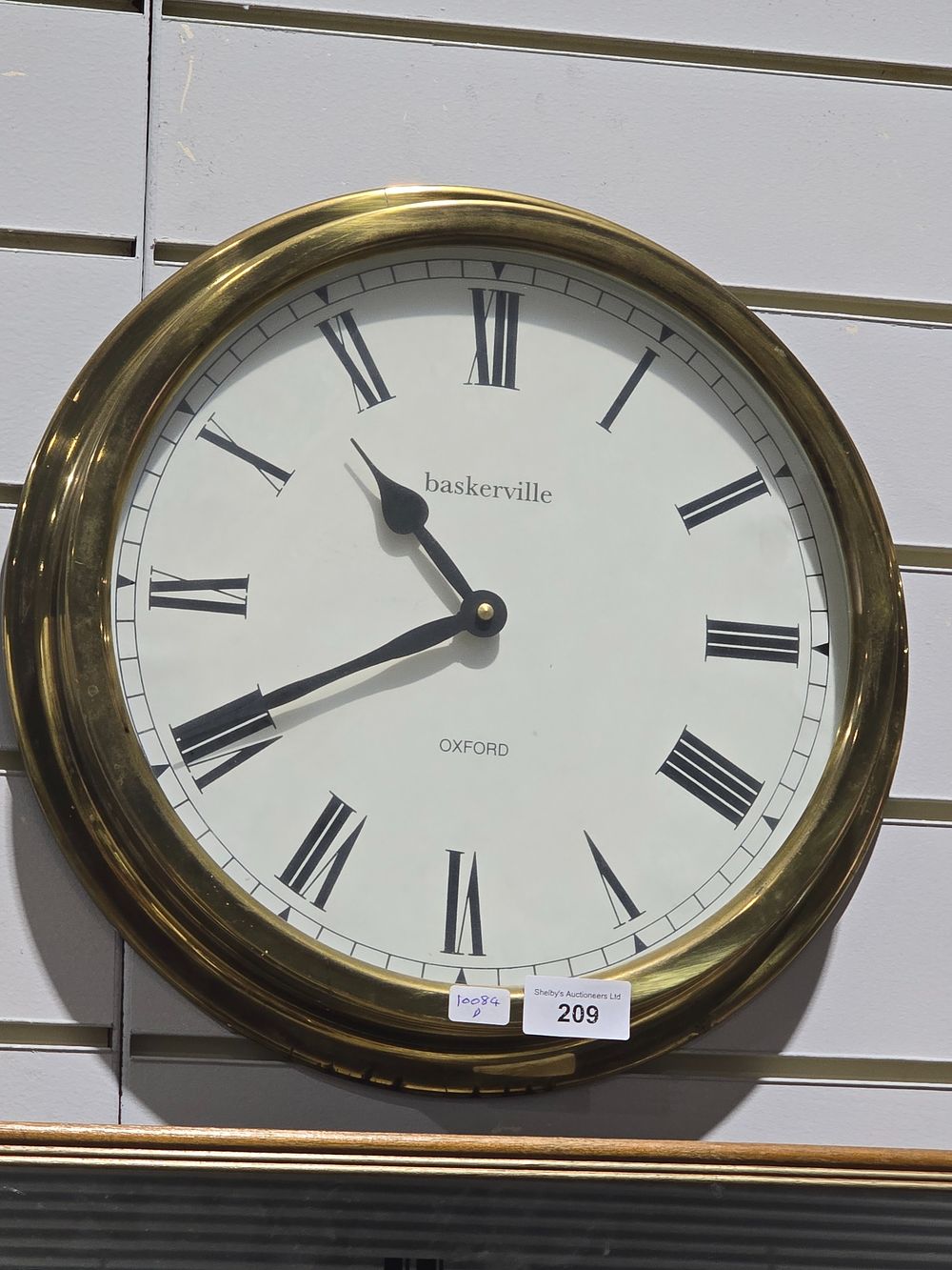 Lot 209: 1 X BRASS BASKERVILLE OXFORD WALL CLOCK BATTERY...