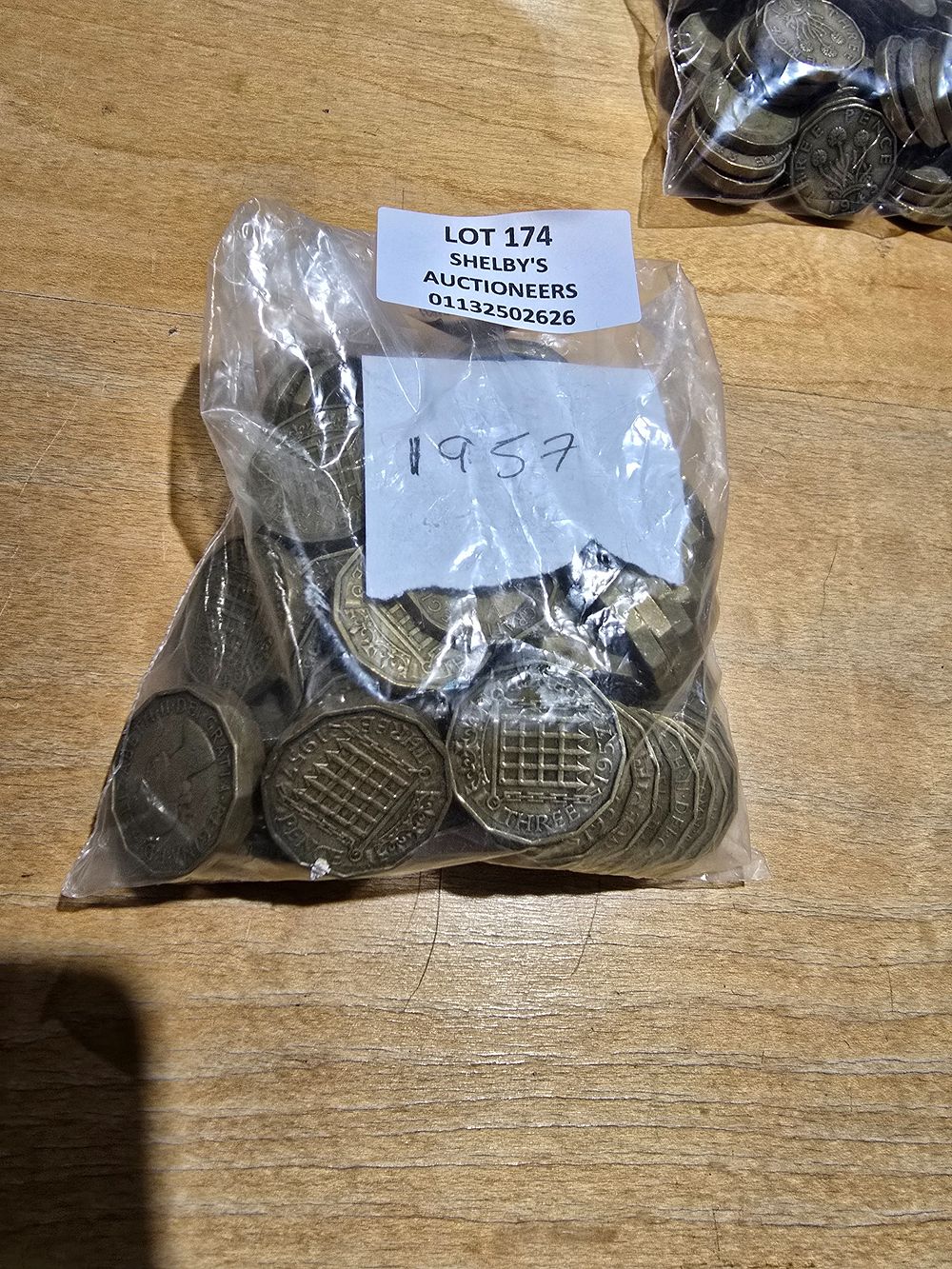 Lot 174: 1 X BAG CONTAINING 1957 THREE PENNY PIECES
