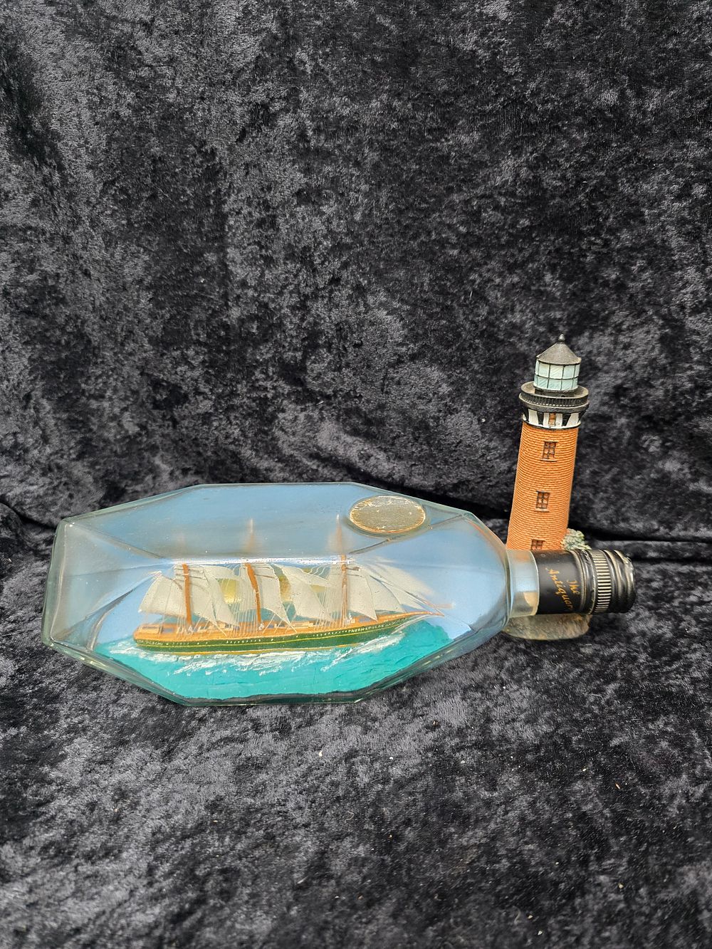 Lot 198: ship in bottle with lighthouse figure