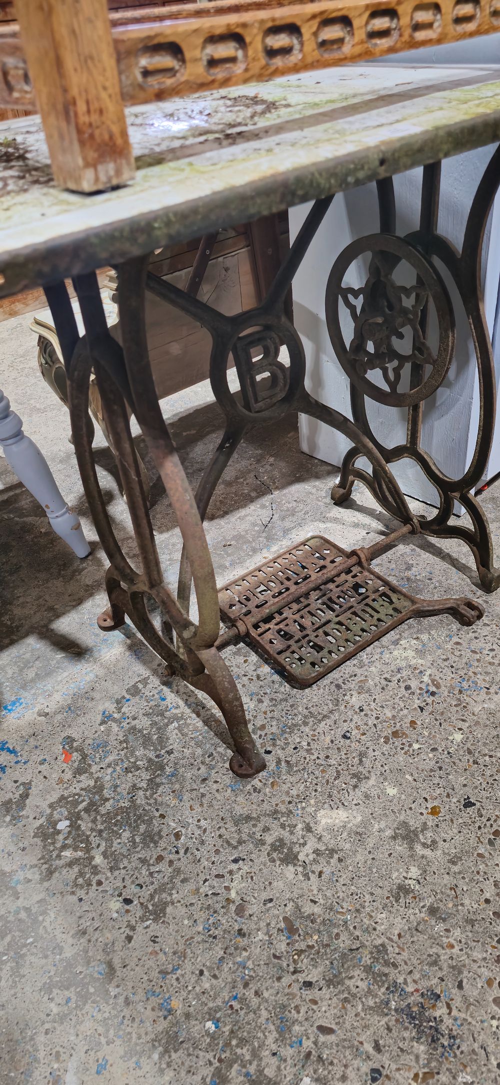 Lot 157: treadle sewing machine table with metal top for outdoors