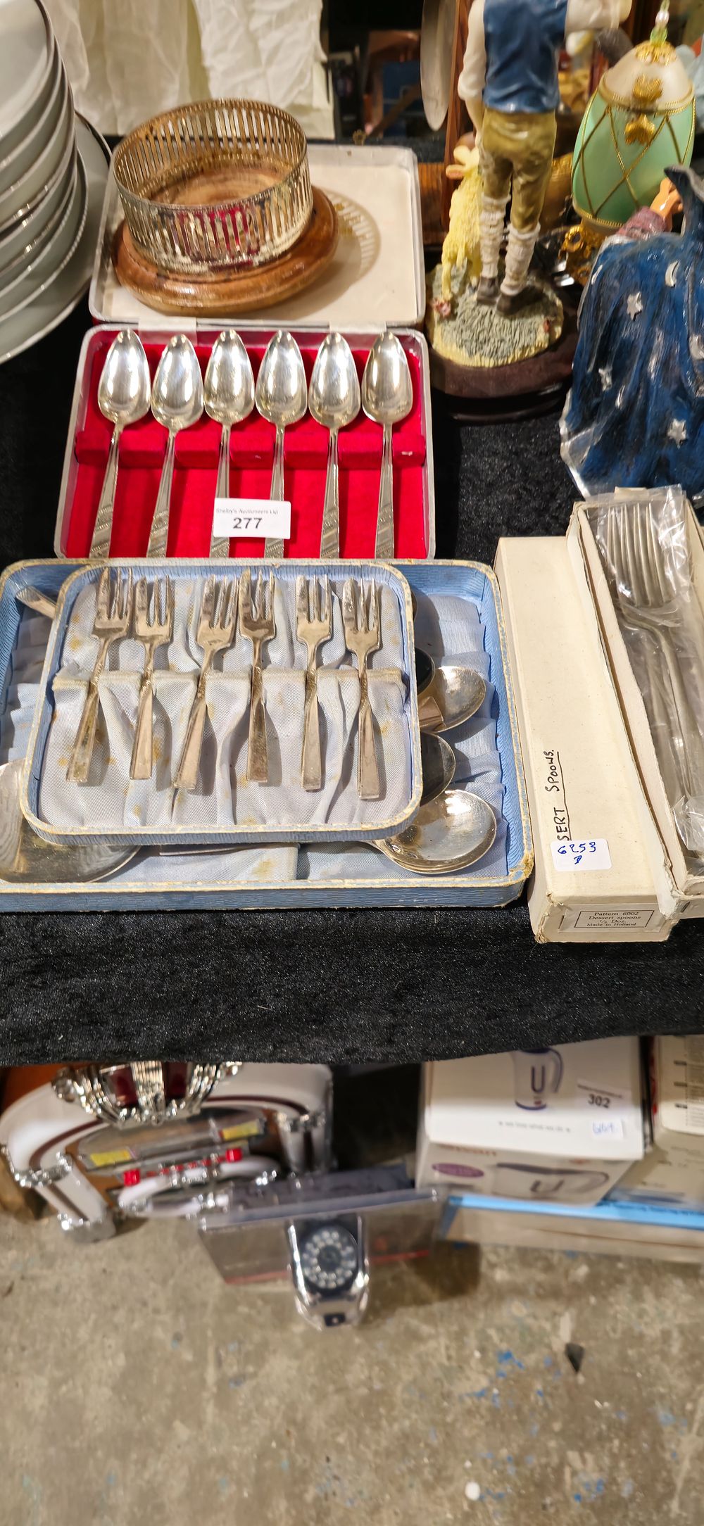Lot 277: selection of metal cutlery ware items with wine bottle coaster