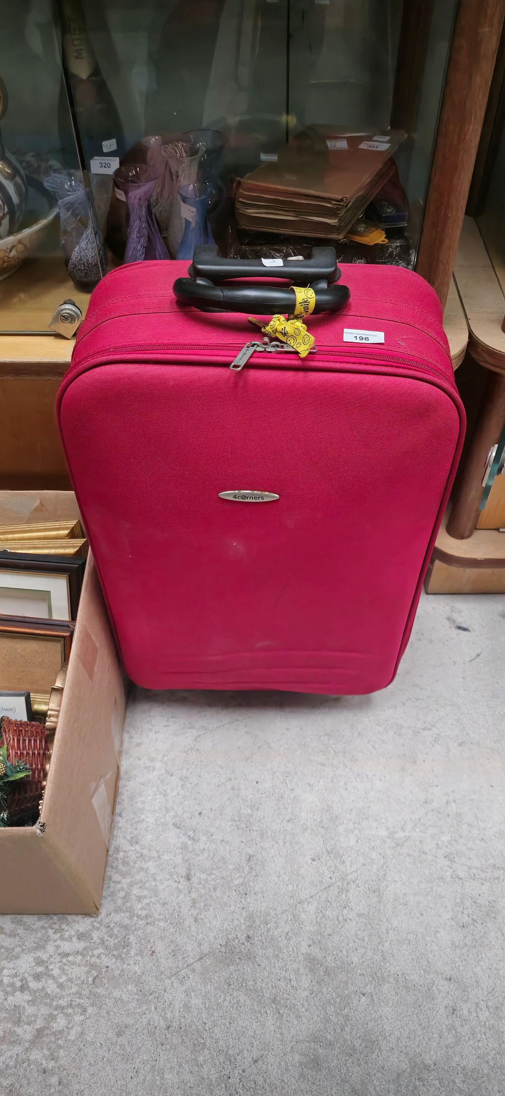 Lot 196: 4 corners red large travell suitcase used