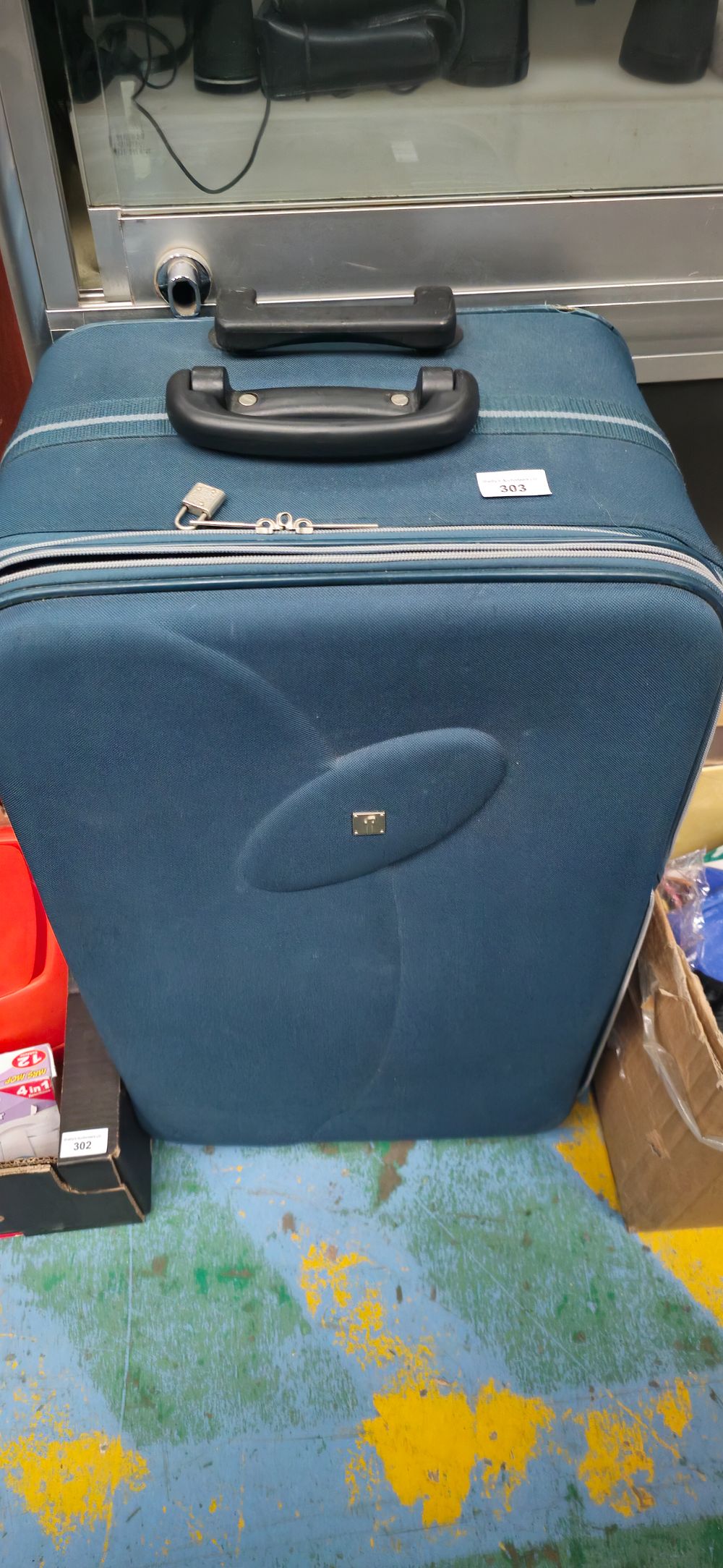 Lot 303: large second hand travelling suit case