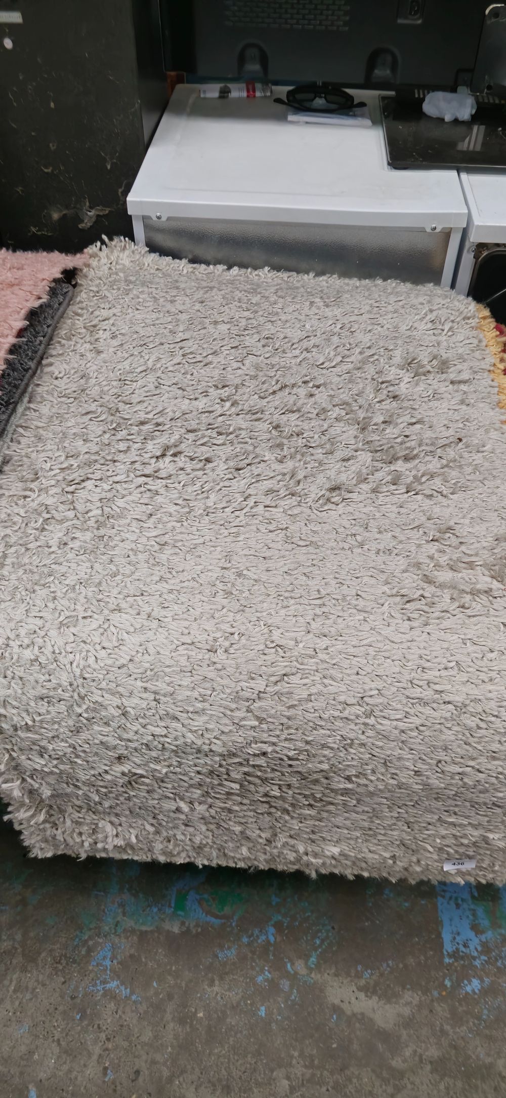 Lot 436: beige small rubber backed new rug 44 x 24