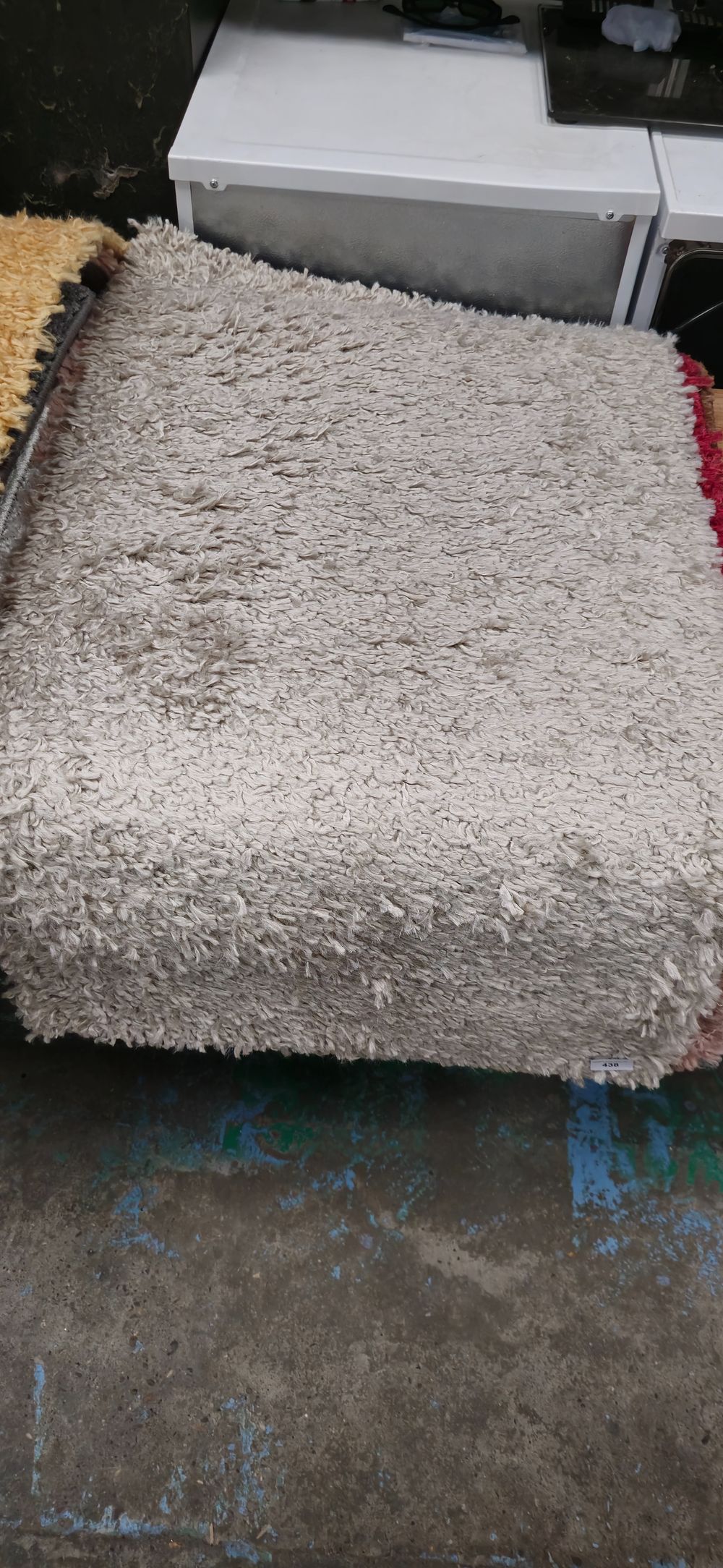 Lot 438: beige small rubber backed new rug 44 x 24