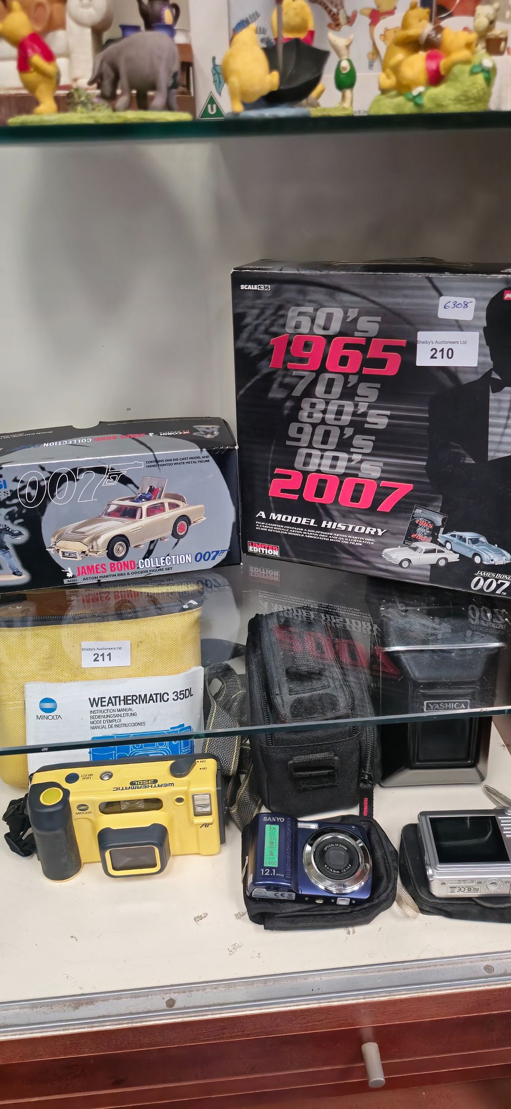 Lot 210: corgi model history 2 car fil reel set with corgi oo7 bond car
