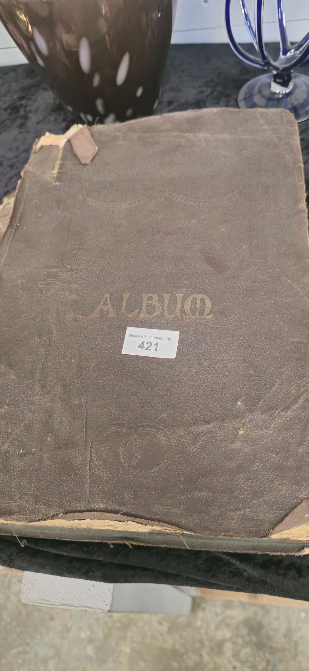Lot 302: 1 x victorian album containg various age postcards album needs attention