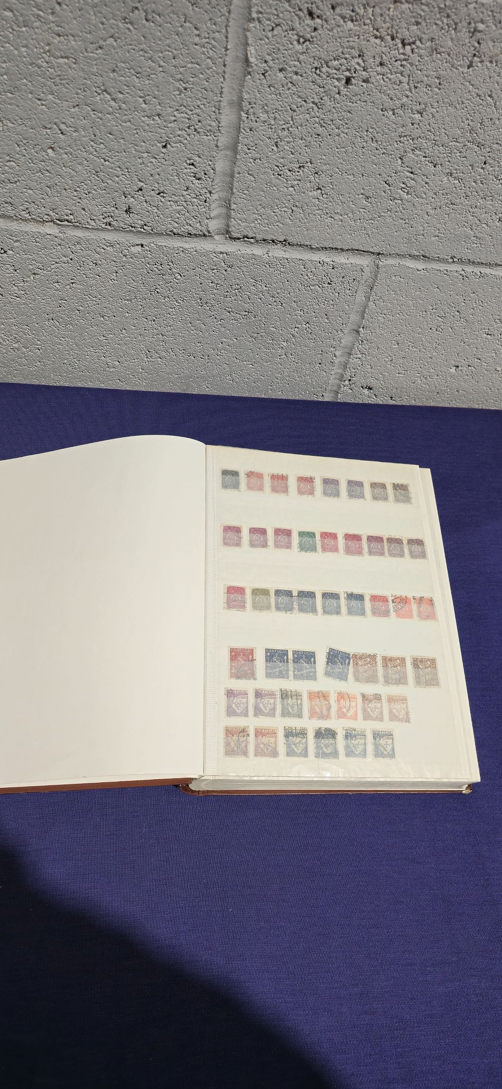 Lot 151: brown stamp book containing 31 pages of foreign stamps portugal mosambique