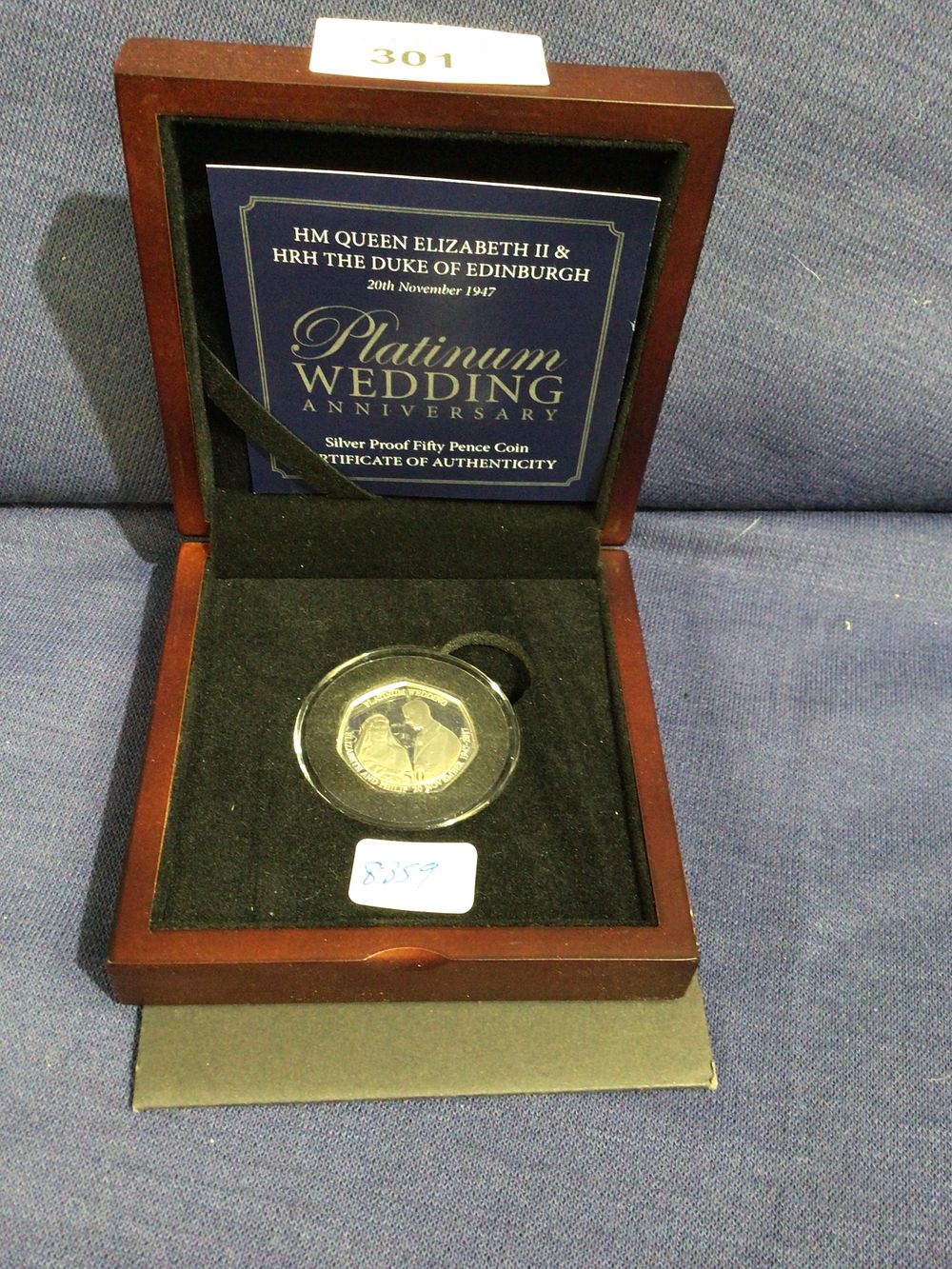 Lot 301: Hm the Queen Elizabeth II & hrh the Duke of Edinburgh platinum wedding anniversary silver proof fifty pence coin complete in box