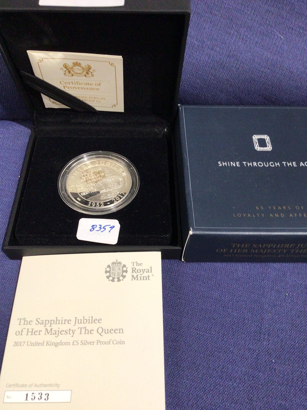 Lot 310: The royal mint sapphire jubilee of her majesty the Queen 2017 United Kingdom £5 silver proof coin