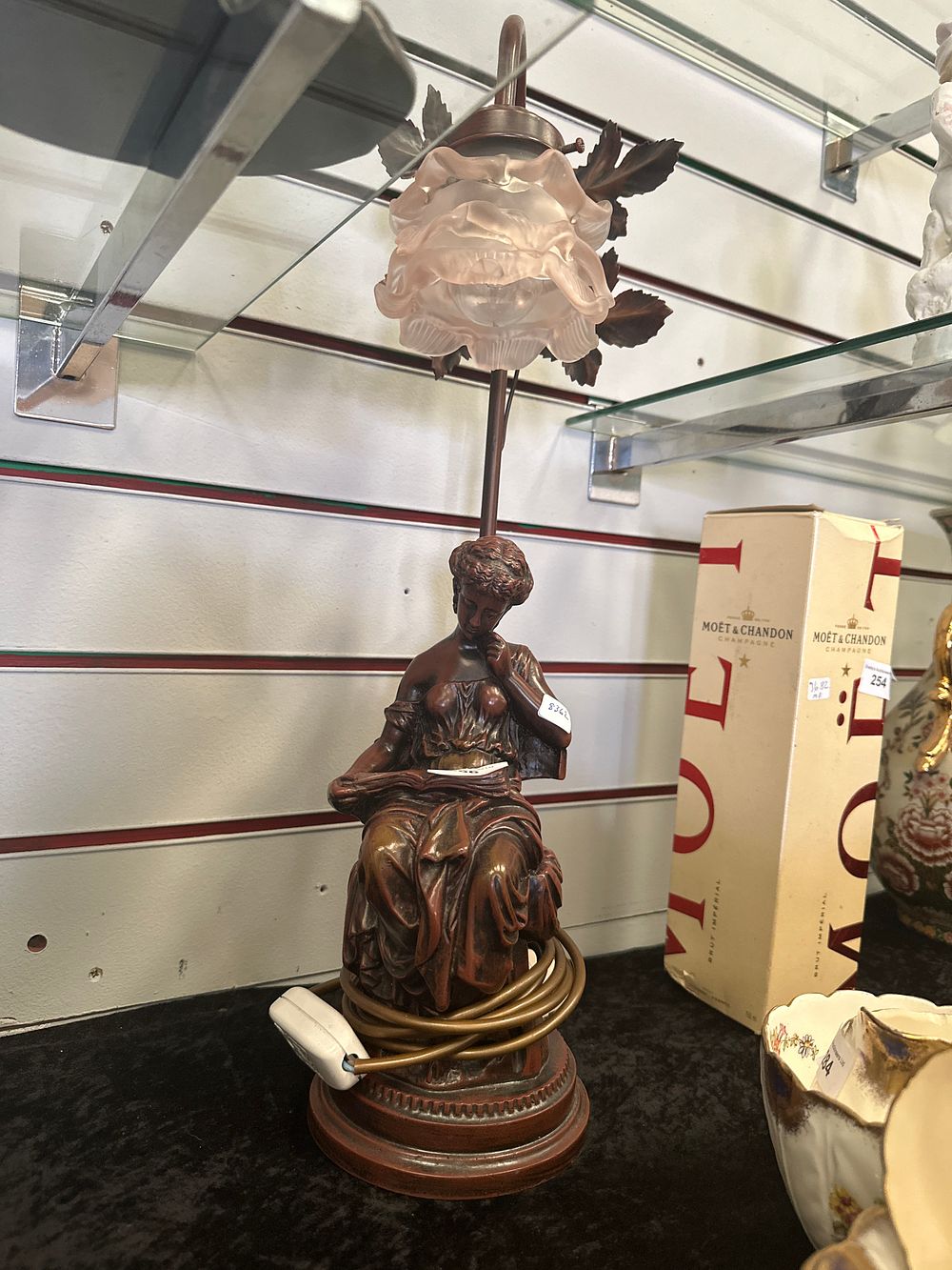 Lot 256: Large resin lady reading book table lamp