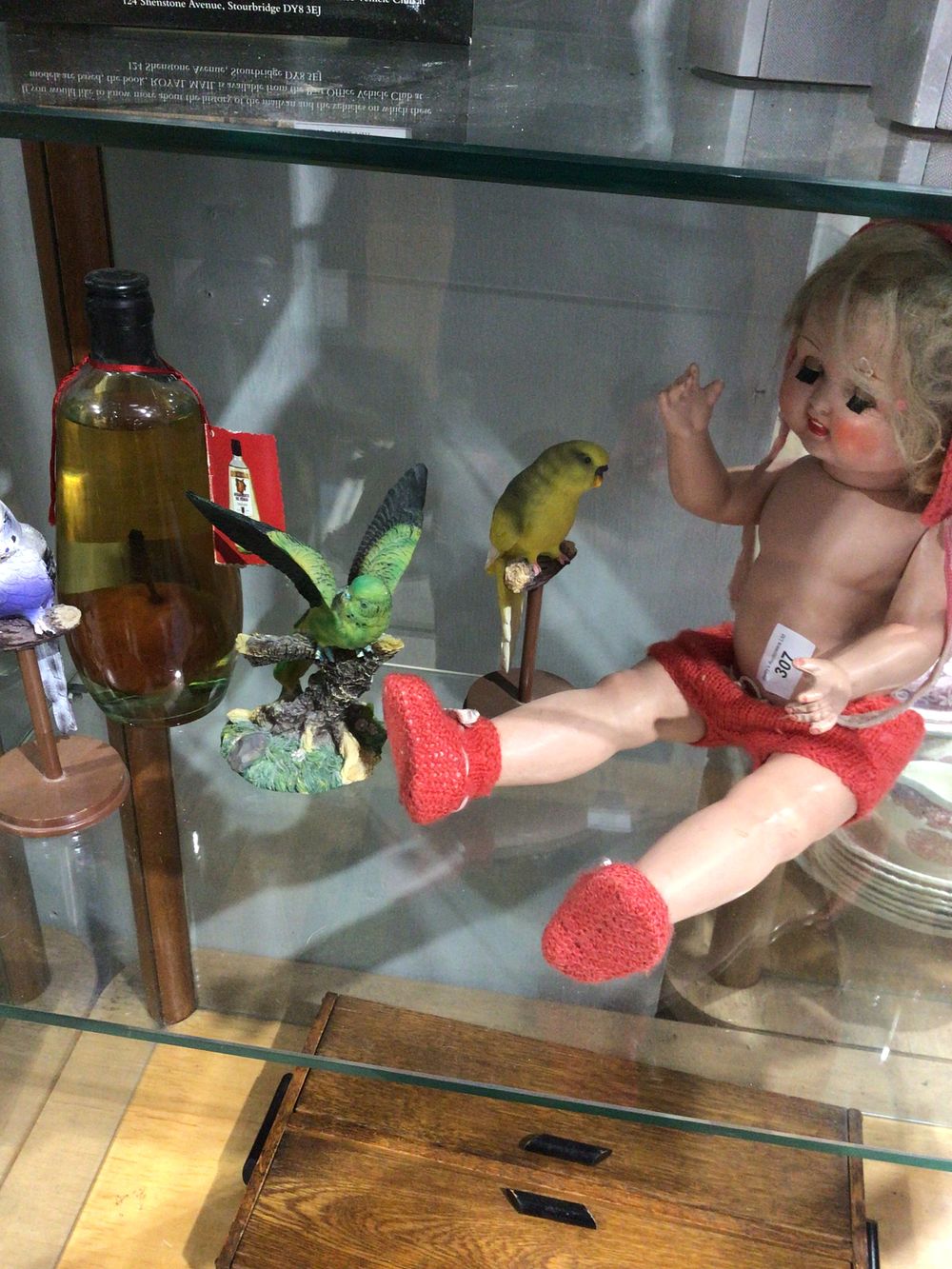 Lot 307: H&S porcelain voice box doll with bird figurines...