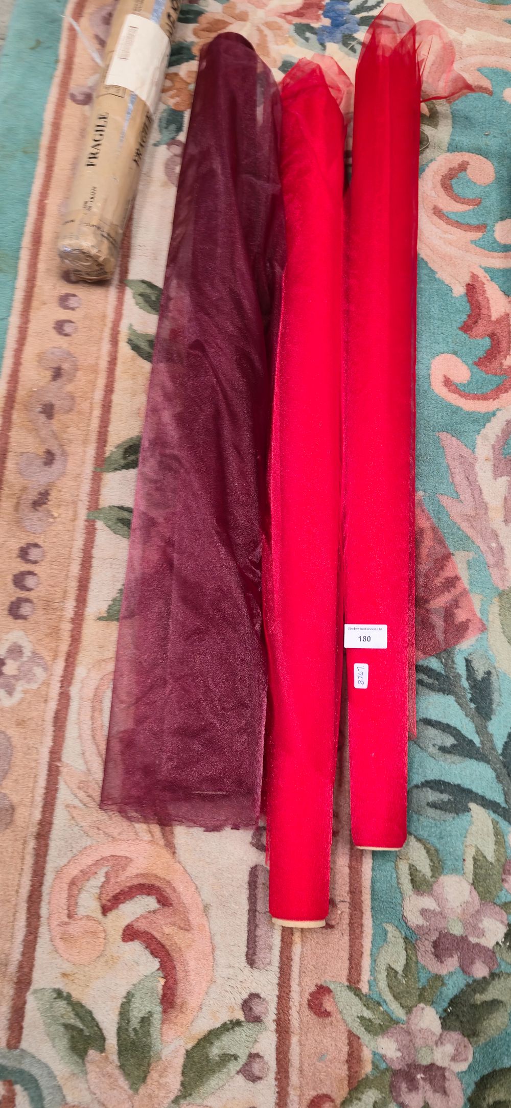 Lot 180: Four various rolls of sheer organza, material, red,...