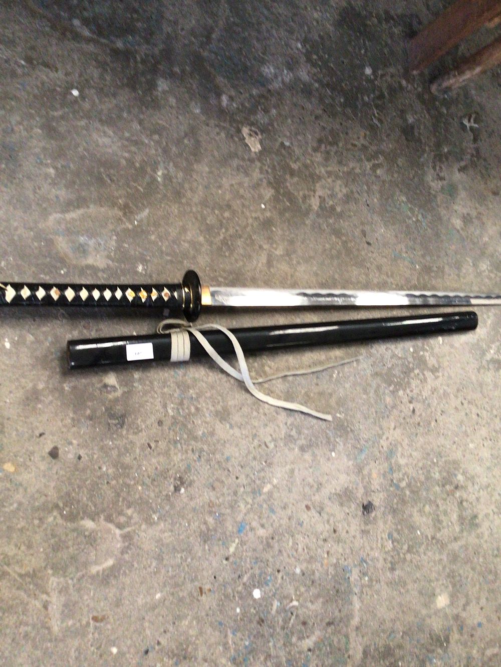 Lot 197: ornamental samurai sword in black sheath