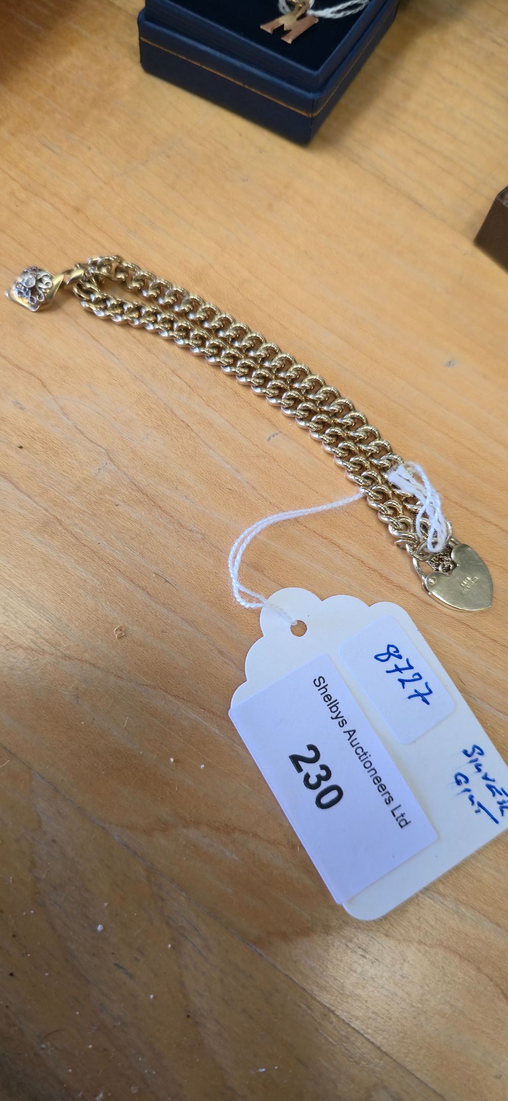 Lot 230: Silvergilt ladies, curb bracelet with charm