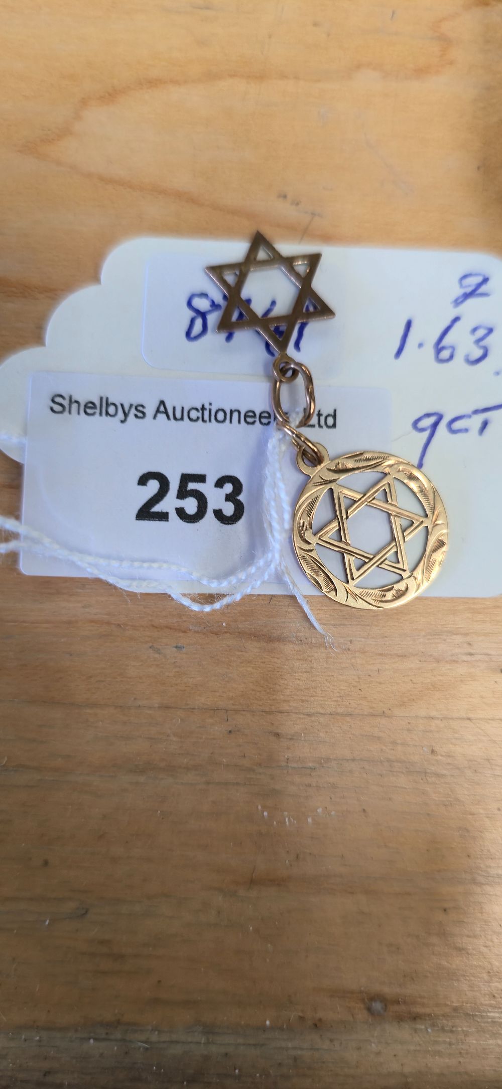 Lot 253: 2 x 9 carat gold star of David...